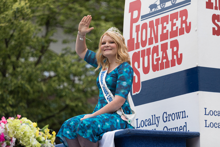Frankenmuth, Michigan, USA - June 10, 2018 The Michigan Sugar Queen, on a float with flowers going down the road at the Bavarian Festival Parade.のeditorial素材