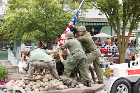Frankenmuth, Michigan, USA - June 10, 2018 Men and a woman dress up as world war two service men reenact the iwo jima flag raise at the Bavarian Festival Parade.のeditorial素材