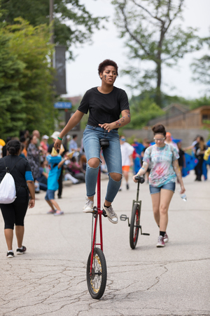 Cleveland, Ohio, USA - June 9, 2018 women wearing colorful outfit riding a unicycle At the abstract art festival Parade The Circleのeditorial素材
