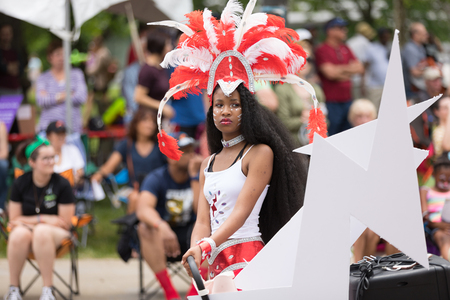 Cleveland, Ohio, USA - June 9, 2018 African american woman wearing a colorful outfit with face paint...