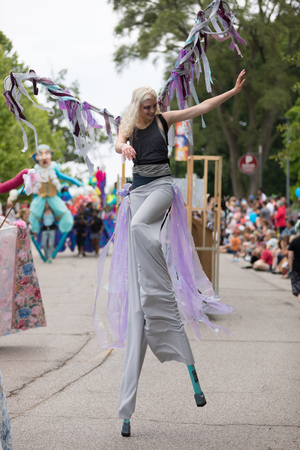 Cleveland, Ohio, USA - June 9, 2018 woman dress up as a butterfly walking on stilts at the abstract art festival Parade The Circleのeditorial素材