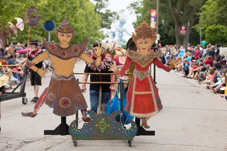 Cleveland, Ohio, USA - June 9, 2018 man pushes a cart with large puppets At the abstract art festival Parade The Circleのeditorial素材