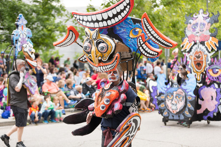 Cleveland, Ohio, USA - June 9, 2018 man wears a costume with faces and smiling mouths At the abstract art festival Parade The Circleのeditorial素材