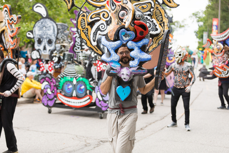 Cleveland, Ohio, USA - June 9, 2018 man wearing a colorful mask with an abstract face  At the abstract art festival Parade The Circleのeditorial素材