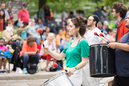 Cleveland, Ohio, USA - June 9, 2018 Young woman playing the drum At the abstract art festival Parade...