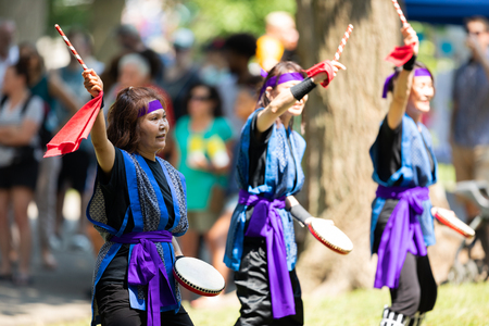 St. Louis, Missouri, USA - August 26, 2018: The Festival of Nations, Asian men and women from the...