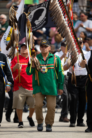 Milwaukee, Wisconsin, USA - September 8, 2018 The Indian Summer Festival, Men and women wearing traditional native american clothing in the ceremony honoring native american military veteransのeditorial素材