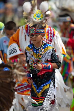 Milwaukee, Wisconsin, USA - September 8, 2018 The Indian Summer Festival, Girl wearing traditional native american clothing, Dancing at the pow wow competition.のeditorial素材