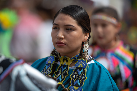 Milwaukee, Wisconsin, USA - September 8, 2018 The Indian Summer Festival Young woman wearing traditional native american clothing at the pow wow competition.のeditorial素材