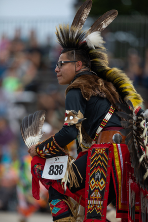 Milwaukee, Wisconsin, USA - September 8, 2018 The Indian Summer Festival, Man wearing traditional native american clothing, dancing at the pow wow competition.のeditorial素材