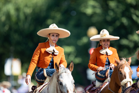Washington, D.C., USA - September 29, 2018: The Fiesta DC Parade, Mexican women charro riding a horse going down the streetのeditorial素材