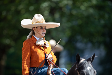 Washington, D.C., USA - September 29, 2018: The Fiesta DC Parade, Mexican women charro riding a horse going down the streetのeditorial素材