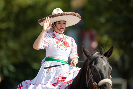Washington, D.C., USA - September 29, 2018: The Fiesta DC Parade, Mexican woman dress up as charro, riding a horse and wearing traditional clothingのeditorial素材