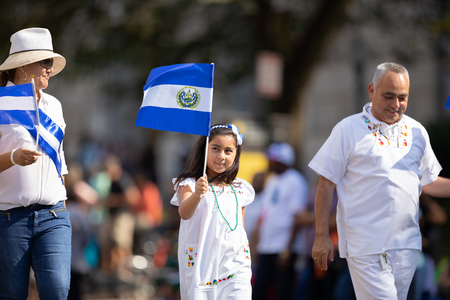 Washington, D.C., USA - September 29, 2018: The Fiesta DC Parade, Woman and girl from El Salvador, waving the El Salvadoran national flagのeditorial素材