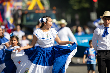 Washington, D.C., USA - September 29, 2018: The Fiesta DC Parade, woman from El Salvador wearing traditional clothing dancingのeditorial素材