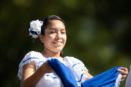 Washington, D.C., USA - September 29, 2018: The Fiesta DC Parade, woman from El Salvador wearing traditional clothing dancingのeditorial素材