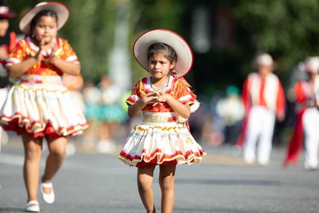 Washington, D.C., USA - September 29, 2018: The Fiesta DC Parade, Young Bolivian girl wearing traditional clothing going down the street during the paradeのeditorial素材