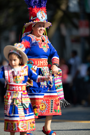 Washington, D.C., USA - September 29, 2018: The Fiesta DC Parade, woman and girl from bolivia wearing traditional clothing dancingのeditorial素材