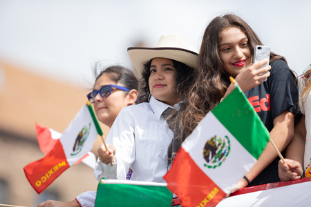 Chicago, Illinois , USA - September 9, 2018 The 26th Street Mexican Independence Parade, mexican women on top of a truck waving mexican flagsのeditorial素材