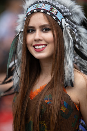 Chicago, Illinois , USA - September 9, 2018 The 26th Street Mexican Independence Parade, mexican woman wearing aztec style traditional clothing walking down the street during the paradeのeditorial素材