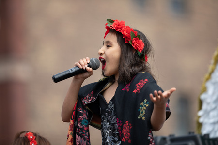 Chicago, Illinois , USA - September 9, 2018 The 26th Street Mexican Independence Parade, Mexican girl wearing traditional clothing on top of a float singing El cielito lindo during the paradeのeditorial素材