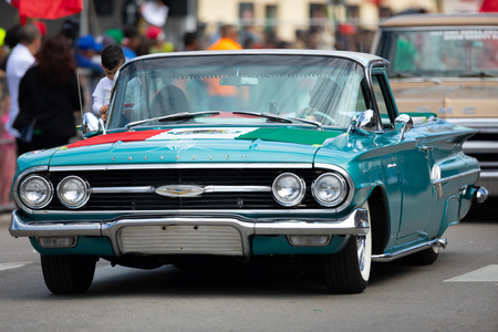 Chicago, Illinois , USA - September 9, 2018 The 26th Street Mexican Independence Parade, Chevrolet Classic car with a mexican flag on the bonnet, going down the streetのeditorial素材