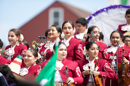 Chicago, Illinois , USA - September 9, 2018 The 26th Street Mexican Independence Parade, Mexican women wearing traditional mariachi clothing playing the violinのeditorial素材