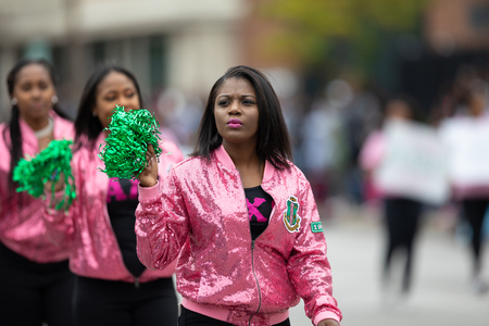 Indianapolis, Indiana, USA - September 22, 2018: The Circle City Classic Parade, African American Women members of Alpha Kappa Alpha wearing pink jackets , walking down the streetのeditorial素材