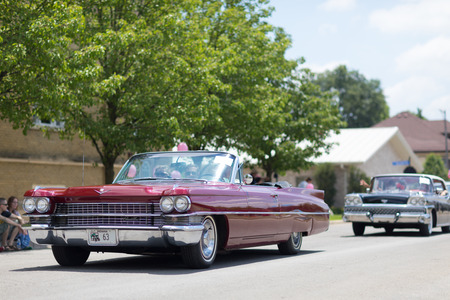 Kokomo, Indiana, USA - June 30, 2018: Haynes Apperson Parade, A Cadillac classic car color red going down the street during the paradeのeditorial素材