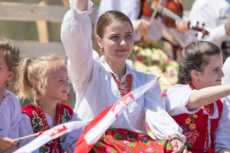 Chicago, Illinois, USA - May 5, 2018: The Polish Constitution Day Parade, polish women and children wearing traditional clothing on a float waving polish flags during the paradeのeditorial素材
