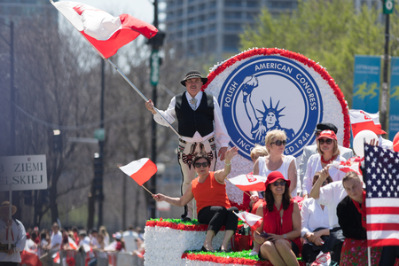 Chicago, Illinois, USA - May 5, 2018: The Polish Constitution Day Parade, Polish man wearing traditional clothing,  goral dress waving the polish flagのeditorial素材