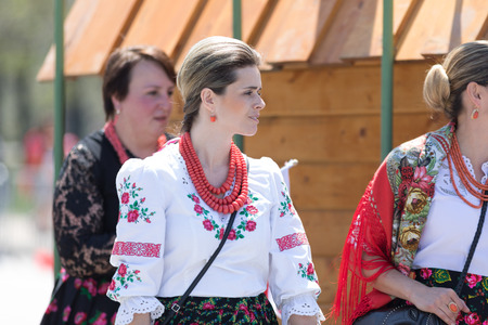 Chicago, Illinois, USA - May 5, 2018: The Polish Constitution Day Parade, Polish woman wearing traditional clothing walking down the street during the paradeのeditorial素材