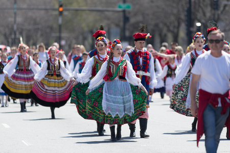 Chicago, Illinois, USA - May 5, 2018: The Polish Constitution Day Parade, Polish men and women wearing traditional clothing singing while walking down the street during the paradeのeditorial素材