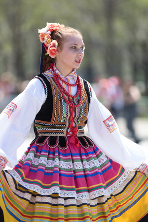 Chicago, Illinois, USA - May 5, 2018: The Polish Constitution Day Parade, Polish woman wearing traditional clothing dancing during the paradeのeditorial素材