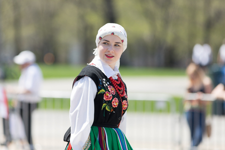Chicago, Illinois, USA - May 5, 2018: The Polish Constitution Day Parade, Polish woman wearing traditional clothing walking down the street during the paradeのeditorial素材