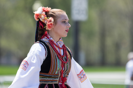 Chicago, Illinois, USA - May 5, 2018: The Polish Constitution Day Parade, Polish woman wearing traditional clothing dancing during the paradeのeditorial素材