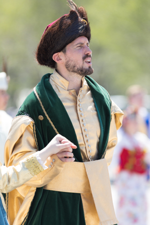 Chicago, Illinois, USA - May 5, 2018: The Polish Constitution Day Parade, Polish men and women wearing traditional clothing members of the Polonia Polish Folk Song and Dance Ensemble singing while walking down the street during the paradeのeditorial素材