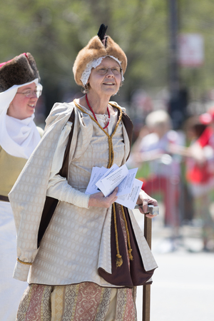 Chicago, Illinois, USA - May 5, 2018: The Polish Constitution Day Parade, Woman wearing traditional polish clothing going down the street during the paradeのeditorial素材