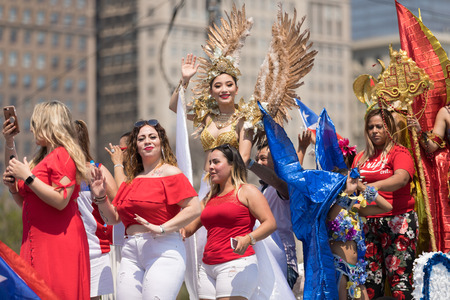 Chicago, Illinois, USA - June 16, 2018: The Puerto Rican Day Parade, Puerto Rican woman wearing traditional clothing on top of a float during the paradeのeditorial素材