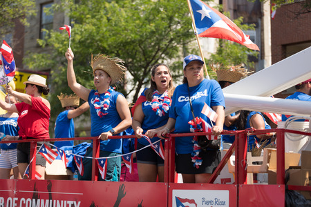 Chicago, Illinois, USA - June 16, 2018: The Puerto Rican People's Parade, Puerto Rican people on top...