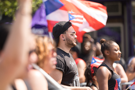 Chicago, Illinois, USA - June 16, 2018: The Puerto Rican People's Parade, puerto rican man with the puerto rican flag during the paradeのeditorial素材