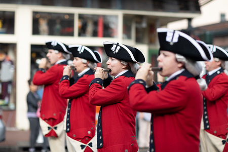 New Orleans, Louisiana USA - November 24, 2018: The Bayou Classic Parade, Old Guard Fife and Drum Corps marching band wearing traditional clothing performing at the parade.のeditorial素材