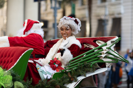 New Orleans, Louisiana USA - November 24, 2018: The Bayou Classic Parade, African American woman riding on a carriage next to Santa Claus,  dress up as Mrs. Clausのeditorial素材