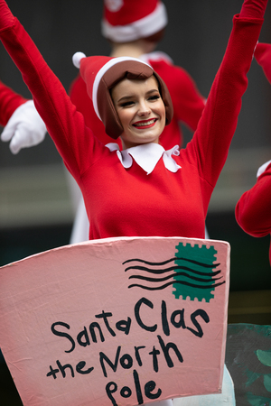 Houston, Texas, USA - November 22, 2018 The H-E-B Thanksgiving Day Parade, Women dress up as Santa's Helpers waving at the spectators, while riding a float.のeditorial素材