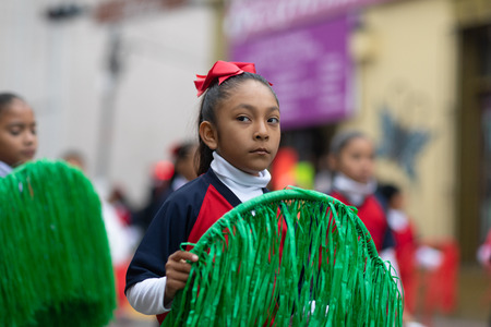 Matamoros, Tamaulipas, Mexico - November 20, 2018: The November 20 Parade, School girls carry rings with the colors of the mexican flag during the paradeのeditorial素材