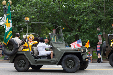 Washington, D.C., USA - May 28, 2018: The National Memorial Day Parade, Military Jeeps with the american and vietnamese flags going down constitution avenueのeditorial素材