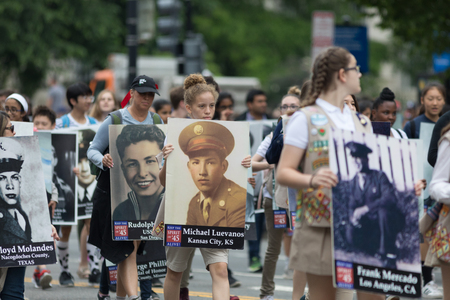 Washington, D.C., USA - May 28, 2018: The National Memorial Day Parade, People carry portraits of...