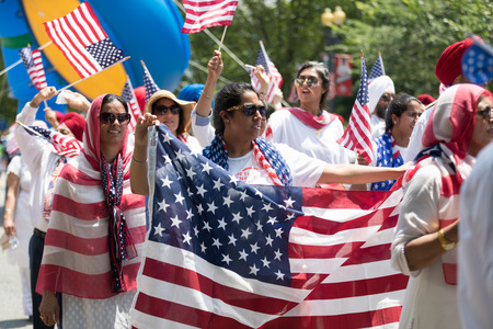 Washington, D.C., USA - July 4, 2018, The National Independence Day Parade, The Sikhs of America, waving american flags, going down constitution avenue during the paradeのeditorial素材