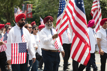 Washington, D.C., USA - July 4, 2018, The National Independence Day Parade, The Sikhs of America, waving american flags, going down constitution avenue during the paradeのeditorial素材