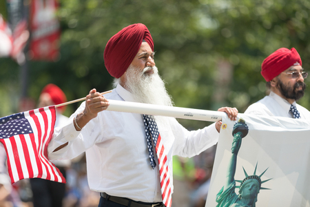 Washington, D.C., USA - July 4, 2018, The National Independence Day Parade, The Sikhs of America, waving american flags, going down constitution avenue during the paradeのeditorial素材